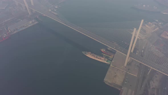 Drone View of the Golden Bridge and the City at Dawn in Heavy Smog alt