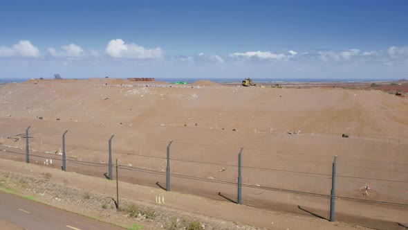 Trash Moving From Garbage Facility Plant To Countryside Field Across Road alt