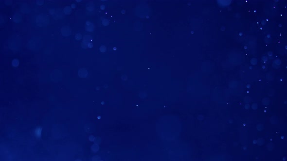 Abstract Shot of Air Bubbles Floating in the Water Against Deep Blue Background alt