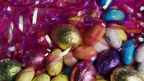 Rotating shot of colorful Easter candies on a bed of easter grass alt