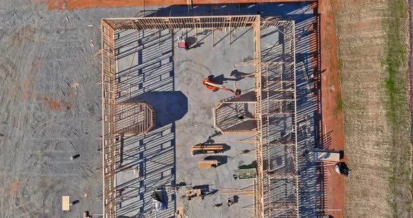 Aerial View of Elevator Shaft for Concrete Block Building Under Construction on Workers are Laying alt