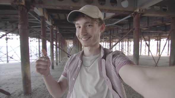 POV Man Under Pier Taking Selfies of Himself in Slow Motion - Ungraded alt