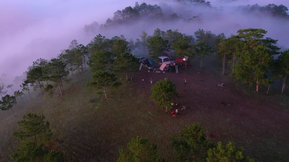 Aerial view of group camping enjoying nature on the hills