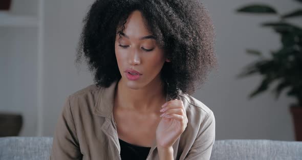 Close Up African Ethnicity Pensive Young Woman Sit on Couch Alone Waits Feels Jealousy. Sad Female alt