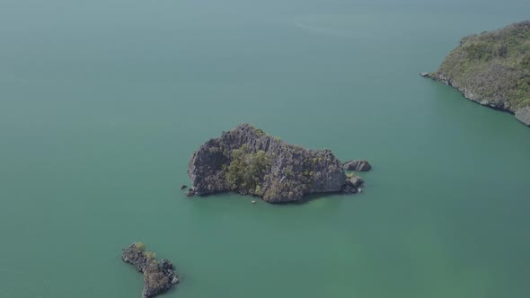Aerial footage of island in sea. Boat floating. Park Kilim Geforest, Langkawi, Malaysia. Nature 
