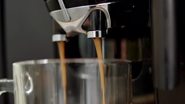 Close Up View of Pouring Liquid Coffee From Automatic Coffee Machine with Chromed Nozzle Into alt