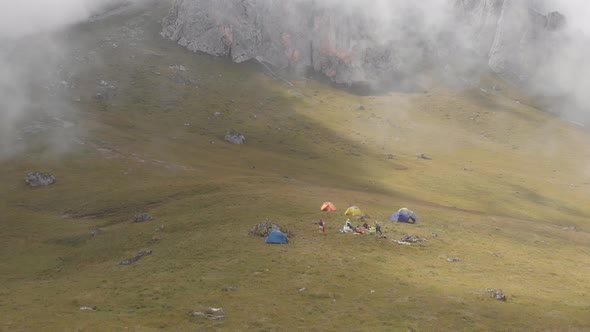 Aerial Shot of a Camp of Climbers in the Mountains Among the Clouds