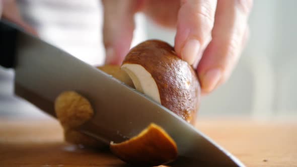 Shot of Woman Chef Cutting Mushrooms on Chopping Wooden Board