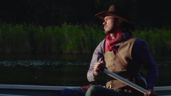 Cowboy in a Canoe Floats on the River alt