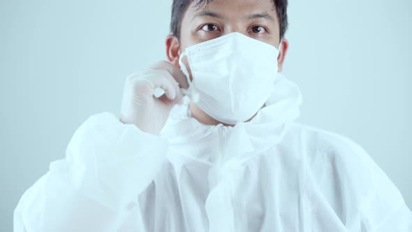 Doctor / Scientist waring PPE suit to protect virus in Covid-19 Corona virus (SARS-CoV-2) pandemic.