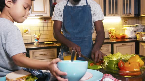 Dad and son preparing breakfast together