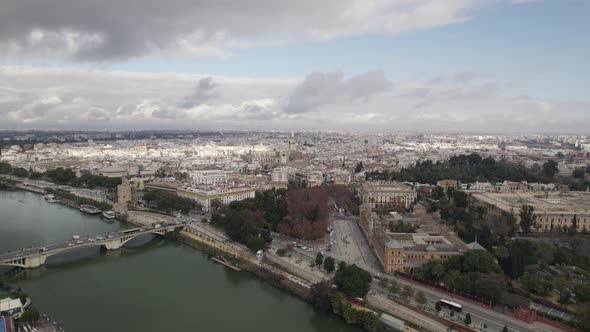Panoramic cityscape of Seville, bridge over Guadalquivir river; aerial left