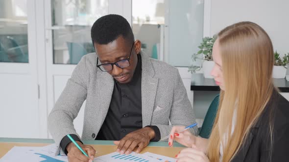 Business Meeting in Office of African Businessman and Caucasian Startup Owner