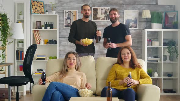 Girls Sitting on Couch Eating Popcorn While Watching Tv alt