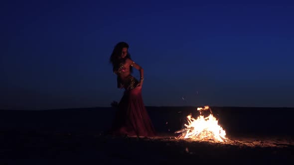 Evening a Girl in the Sand Dancing Belly Dancing Near a Bright Campfire alt