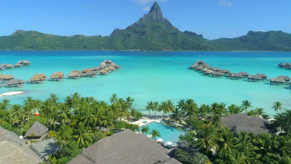 Aerial drone view of a luxury resort and overwater bungalows in Bora Bora tropical island alt