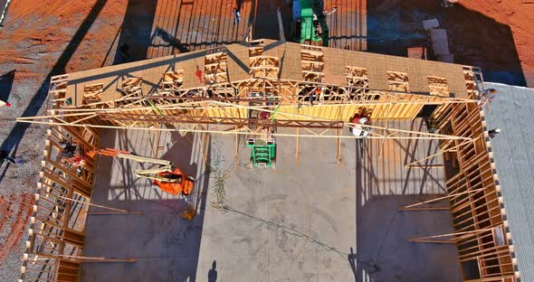 Wooden Roof with Crane Holds a Roof Truss Beams alt