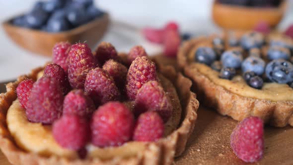 Raspberry And Blueberry Tartlet Cakes Closeup. alt