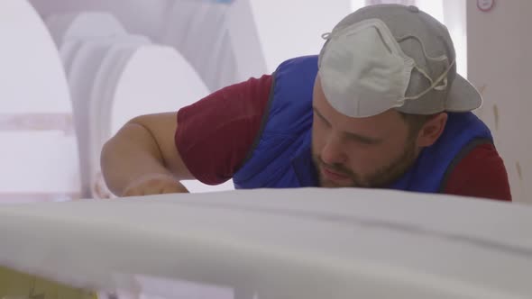 Male surfboard maker in his workshop alt