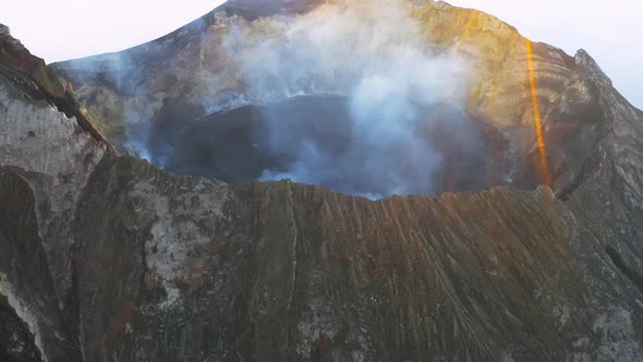 Aerial View of Volcano Crater with Steam in Mountains alt