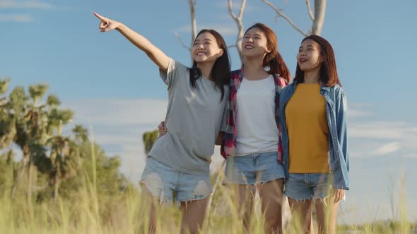 Young Asian woman looks to view the mountain and having fun together a summer traveling.