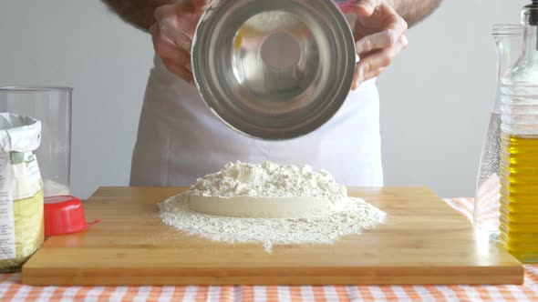 Man forming flour for pizza dough