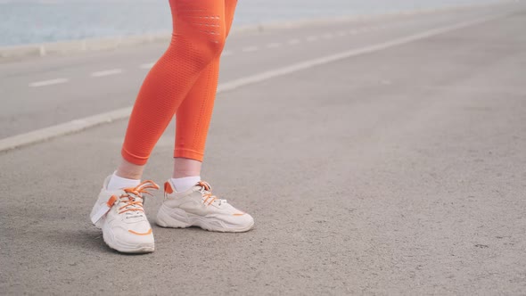 The concept of sports healthy lifestyle. Outdoor leg exercises. Girl sports training. Nice legs in l alt