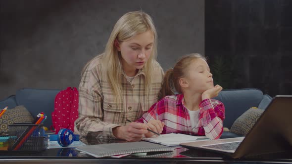 Caring Mother Teaching Math To Lazy Girl Indoors alt