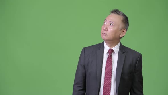 Mature Japanese Businessman Shocked and Surprised While Looking Up alt