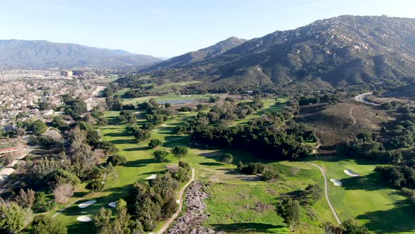 Aerial View of Golf Course with Green Field in the Valley alt