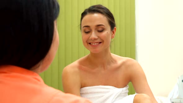 Beauty Specialist Points Her Forefinger on Woman's Chest alt