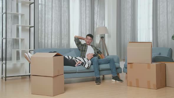 Young Asian Couple Carrying Cardboard Boxes. They Move Into A New House Together alt