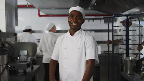 Portrait of african american male chef with arms crossed looking at camera alt