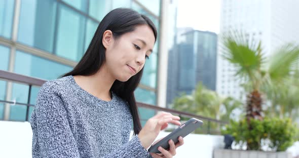 Woman use of smart phone in city alt