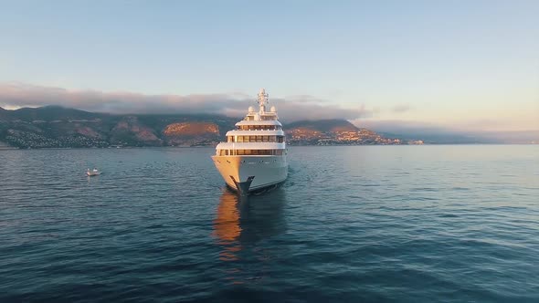 Front View of Large Super Yacht and Small Boat Underway. Luxury Super Yacht. alt