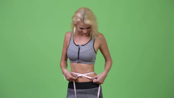 Young Happy Beautiful Woman Measuring Her Waist