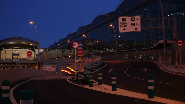 Nighttime at an international airport terminal with signs in Spanish - long exposure time lapse with alt