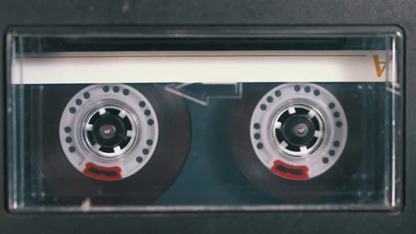 Audio Cassette Is Inserted Into the Deck of the Audio Tape Recorder Playing and Rotates alt