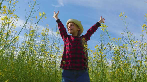 Happy Little Girl with Hat with Her Hands Up alt