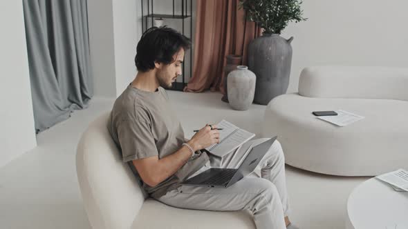Freelancer Taking Notes in Living Room alt