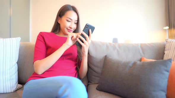 Young asian woman use smart phone alt