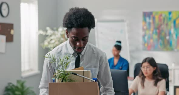 Man with Afro Hair Quits Company Job Walks Out of Office with Things Packed in Box Leaves alt