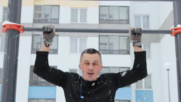 Man training outdoors on sports field in winter