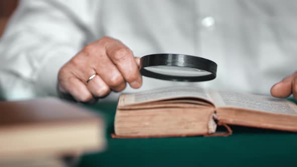 Closeup Elderly Man Hands Reading Old Retro Text Book Use Magnifying Glass Searching Information alt