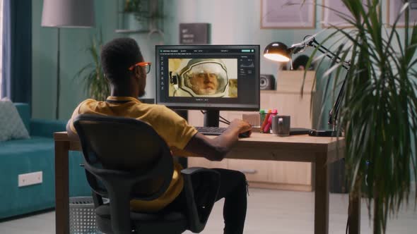 Black Guy Using Photo Editor on Computer alt