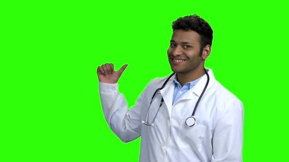 Cheerful Doctor Pointing To Copy Space. alt