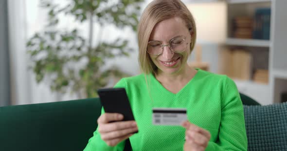 Woman Using Credit Card and Mobile