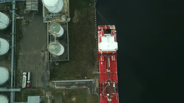 Cargo ship in port aerial view alt