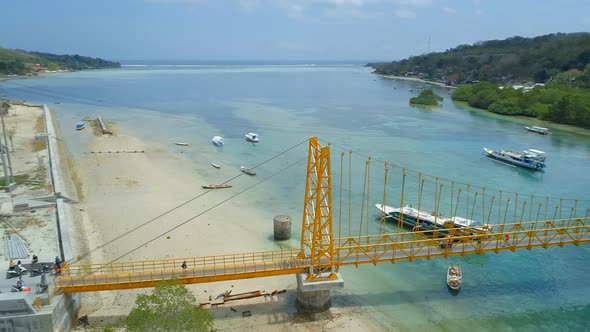 The Yellow Bridge Connecting Nusa Lembongan and Cennigan Islands in Bali alt