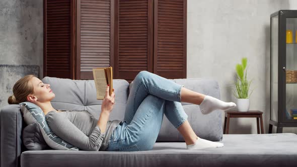 Young woman works with documents using a laptop at home. alt